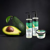 Línea capilar Organic Shop Palta y Miel junto a una palta partida