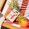 Bálsamo labial solar Lovea FPS 50 junto a frutas tropicales